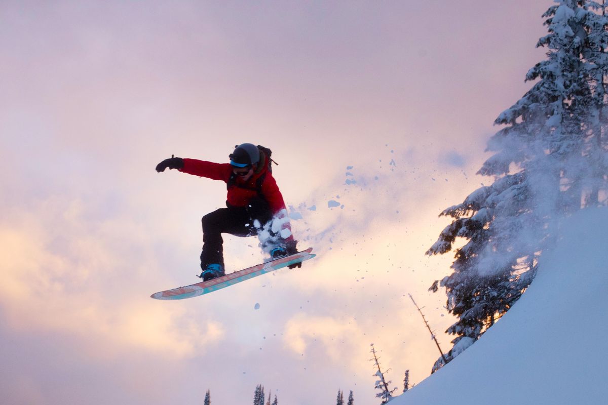 Kyle Breeding gets some air while snowboarding down Tiger Peak on Feb. 10, 2020. (Eli Francovich / The Spokesman-Review)