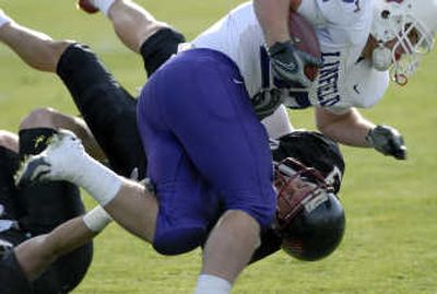 
Whitworth's Jay Tully, bottom, wrestles Linfield's Dan Lever to the ground during Saturday's game at the Pine Bowl. 
 (Dan Pelle / The Spokesman-Review)