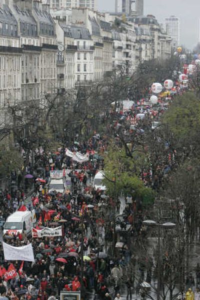
Striking civil servants jam a street in Paris on Tuesday. In the northern France city of Lille, below, police protest government plans to reform special retirement benefits. Associated Press photos
 (Associated Press photos / The Spokesman-Review)