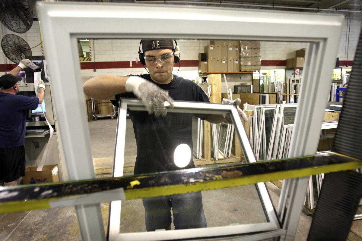 Wallside Windows assemblyman Sam Bernat puts together a window at the factory in Taylor, Mich. Orders to U.S. factories for manufactured goods from computers to aircraft surged in May.Associated Press photos (Associated Press photos / The Spokesman-Review)