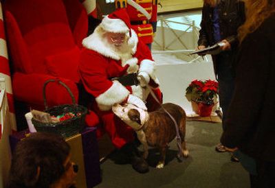 
Santa meets Chiefia before posing for a holiday portrait Tuesday at NorthTown Mall. Santa with hold all creatures except for cats, which, due to his allergies, have to be held at a distance. 
 (Brian Plonka / The Spokesman-Review)