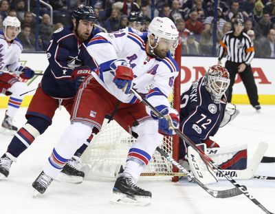 New York Rangers' Rick Nash, center, takes a shot against Columbus Blue Jackets' Sergei Bobrovsky, right, of Russia, as Brandon Dubinsky defends during the third period of an NHL hockey game Monday, Feb. 13, 2017, in Columbus, Ohio. (Jay LaPrete / Associated Press)