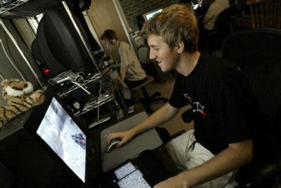 
Johnathan Wendel sits at his computer in his Kansas City, Mo., home Wednesday as he practices for an upcoming professional gaming tournament.  
 (Associated Press / The Spokesman-Review)