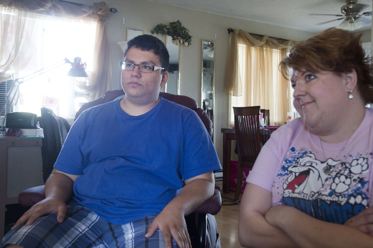 Tomie Tsosie Leeds, left, and his mother, Jenn Leeds, talk about Tomie’s situation Tuesday, after he failed to pass two end-of-course tests in high school biology at Rogers High School. The high school junior has high grades in all other classes and is stymied by the requirement to pass the test. (Jesse Tinsley)