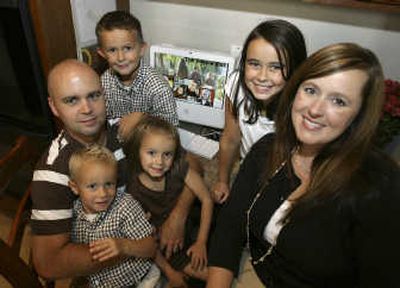 Mark and Corrie Pankow with their children, clockwise from upper left, Carter, 6, Makenzie, 9, Sydney, 5, and Davis, 3, in their home in Peoria, Ariz.Associated Press
(Associated Press / The Spokesman-Review)