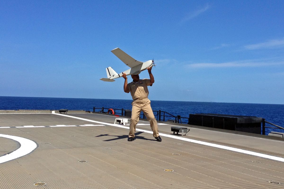 U.S. Navy Rear Adm. Sinclair Harris prepares lo launch a unmanned aircraft system named Puma from the deck of High-Speed Vessel Swift on Friday. (Associated Press)