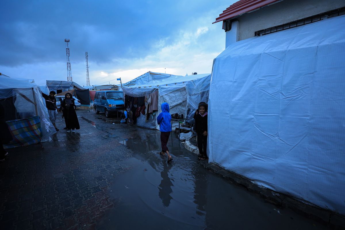 Heavy rain across Gaza worsens conditions at a camp in Khan Younis on Sunday.    (Loay Ayyoub/For The Washington Post)