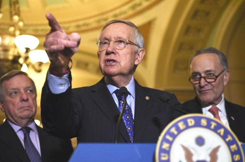 Senate Minority Leader Harry Reid of Nev., flanked by Senate Minority Whip Richard Durbin of Ill., left, and Senate Minority Leader-elect Charles Schumer of N.Y., answers questions from the media after the Democratic policy luncheon on Capitol Hill in Washington, Tuesday. (Sait Serkan Gurbuz / Associated Press)