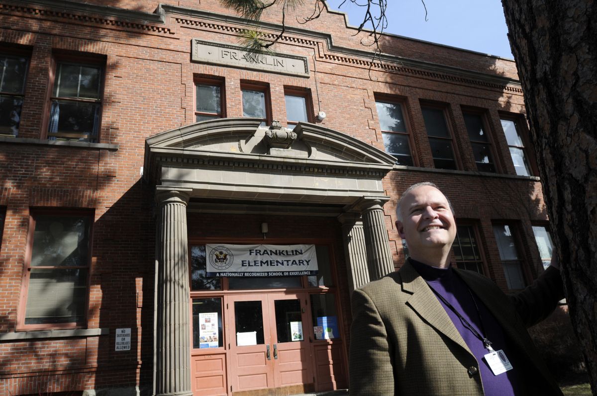 Brian Shute, a speech pathologist at Franklin Elementary, stands in front of the school last month. The school is 100 this year.  (Jesse Tinsley / The Spokesman-Review)