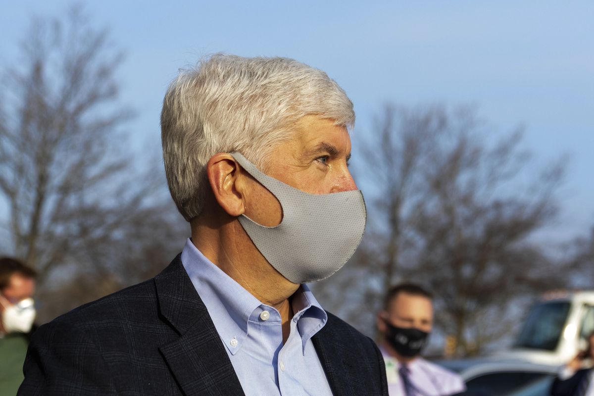 Former Gov. Rick Snyder stays silent as barrage of media asks questions after his video arraignment on charges related to the Flint water crisis, Thursday, Jan. 14, 2021 outside the Genesee County Jail in downtown Flint, Mich.  (Cody Scanlan)