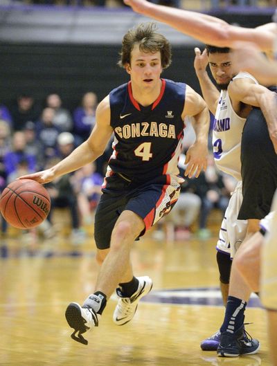 Gonzaga guard Kevin Pangos, driving past Alec Wintering, accounted for 17 points in the final 15 minutes, 30 seconds. (Associated Press)