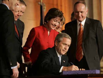
 Rep. Jane Harman, D-Calif., and House Intelligence Committee Chairman Rep. Peter Hoekstra, R-Mich., watch President Bush sign the intelligence reform bill into law on Dec. 17 in Washington. 
 (File/Associated Press / The Spokesman-Review)