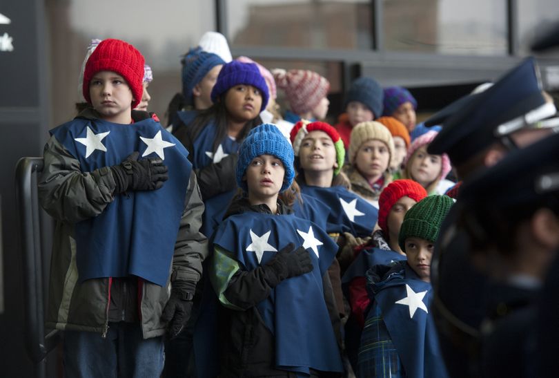 Third-graders from McDonald Elementary listen to the national anthem while waiting to sing near the truck carrying the Capitol Christmas Tree on Tuesday outside the INB Performing Arts Center. The tree is starting a regional tour before heading to Washington, D.C (Jesse Tinsley)