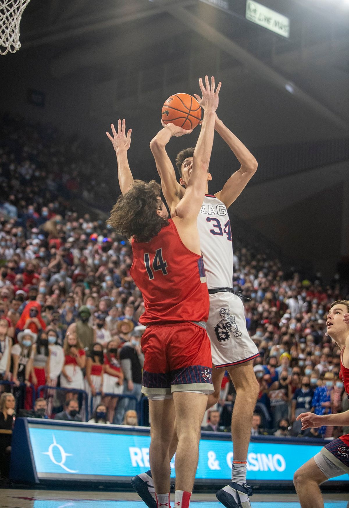Gonzaga's Chet Holmgren (34) spins in the lane to shoot over St. Mary's Kyle Bowen (14) in the first half of the West Coast Conference game Saturday, Feb. 12, 2022 at McCarthey Athletic Center at Gonzaga University in Spokane, Washington.  (Jesse Tinsley/The Spokesman-Review)