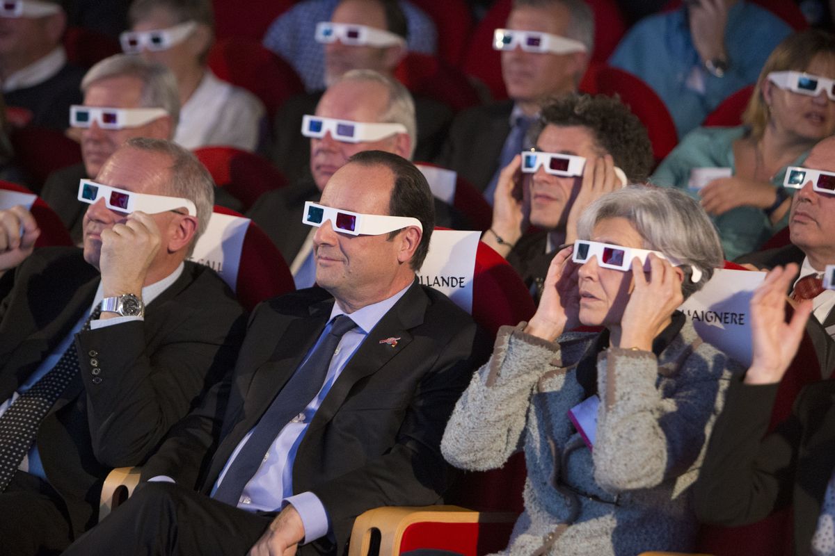 French President Francois Hollande, foreground center, sits with other dignitaries while watching the Rosetta mission Wednesday in Paris. (Associated Press)