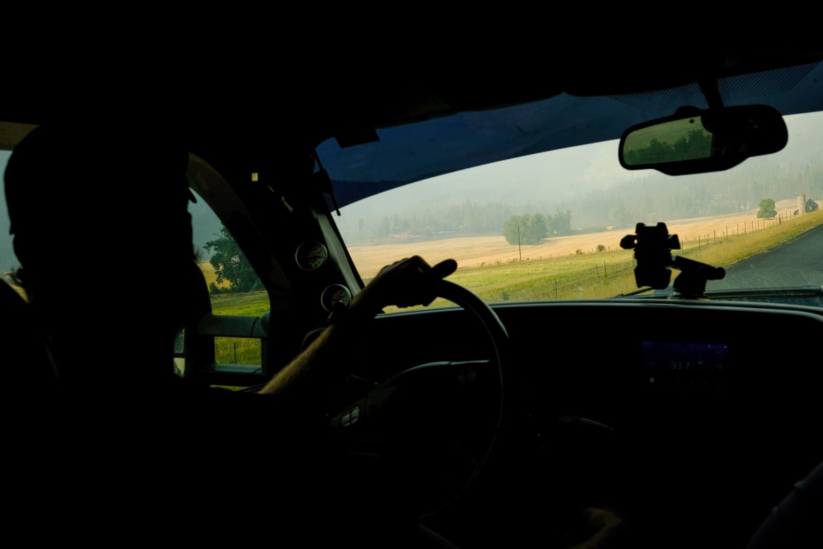 Jordan Pyeatt looks out the windshield of his pickup as he returns to his home off of Rail Canyon Road after it was destroyed on Monday by the Ford-Corkscrew Fire on Wednesday, Aug. 18, 2021, near Tumtum, Wash.  (Tyler Tjomsland/The Spokesman-Review)