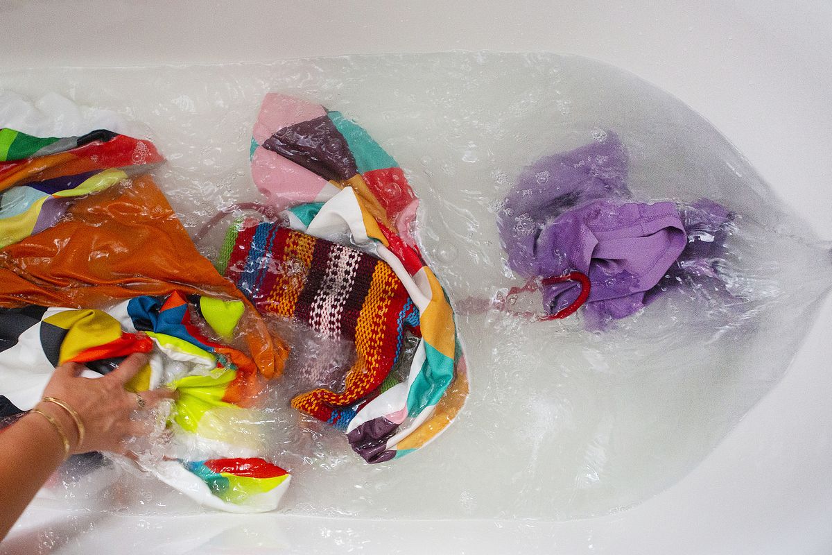 One fabric care scientist cautions that a satisfyingly dark tub of water in a social media reveal can include not just a buildup of dirt but also dye from the fabrics and even fibers lost during stripping.  (Calla Kessler/For the Washington Post)
