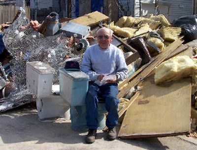 
Harold Schoessler of Zion Philadelphia United Church of Christ in Ritzville sits amid a heap of debris taken from a New Orleans home. 
 (Randy Crowe The Fig Tree / The Spokesman-Review)