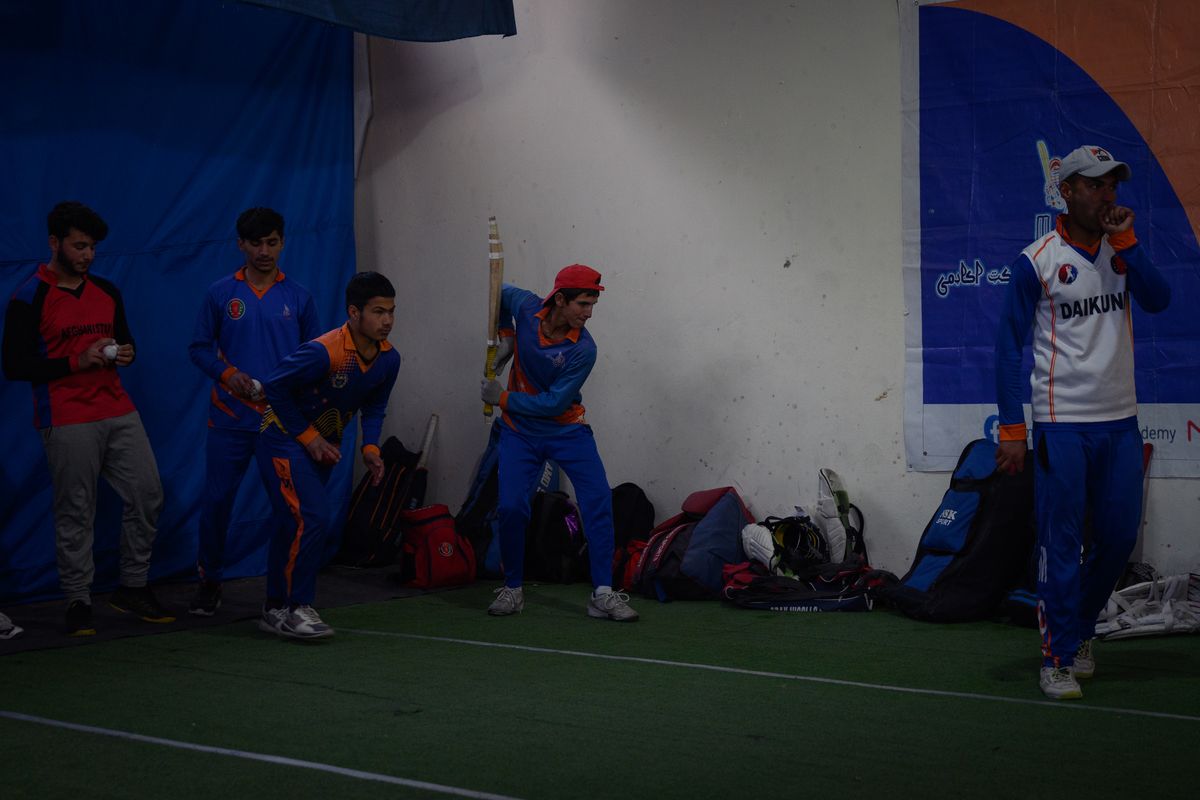 Afghan cricket players practice at a private academy in Kabul. The Taliban government is focused on turning Afghanistan into a global cricketing power, and cricket academies have seen a rise in sign-ups.   (Elise Blanchard/For The Washington Post)