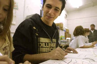 
Zane Kimes, a North Idaho College student, helps kids work on abstract art while he spends time as a volunteer at Art on the Edge. 
 (Jesse Tinsley/The Spokesman-Revi / The Spokesman-Review)