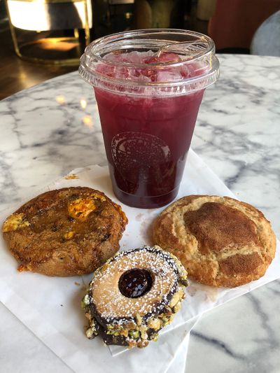 A Rooibos Berry Lemonade, toffee nut cookie, raspberry shortbread wheel and snickerdoodle at Emma Rue’s Coffee and Cocktails on Aug. 24.  (Don Chareunsy/The Spokesman-Review)