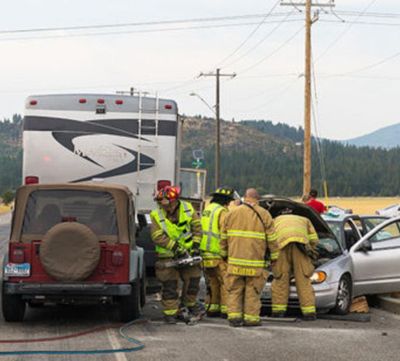 Crews from Kootenai County Fire and Rescue work the scene of a two-car collision that occurred Monday afternoon near the intersection of Pleasant View Road and Prairie Avenue in Post Falls. Nancy Colon, 33, of Shoreline, WA, was killed in the accident. (Shawn Gust / Coeur d'Alene Press)