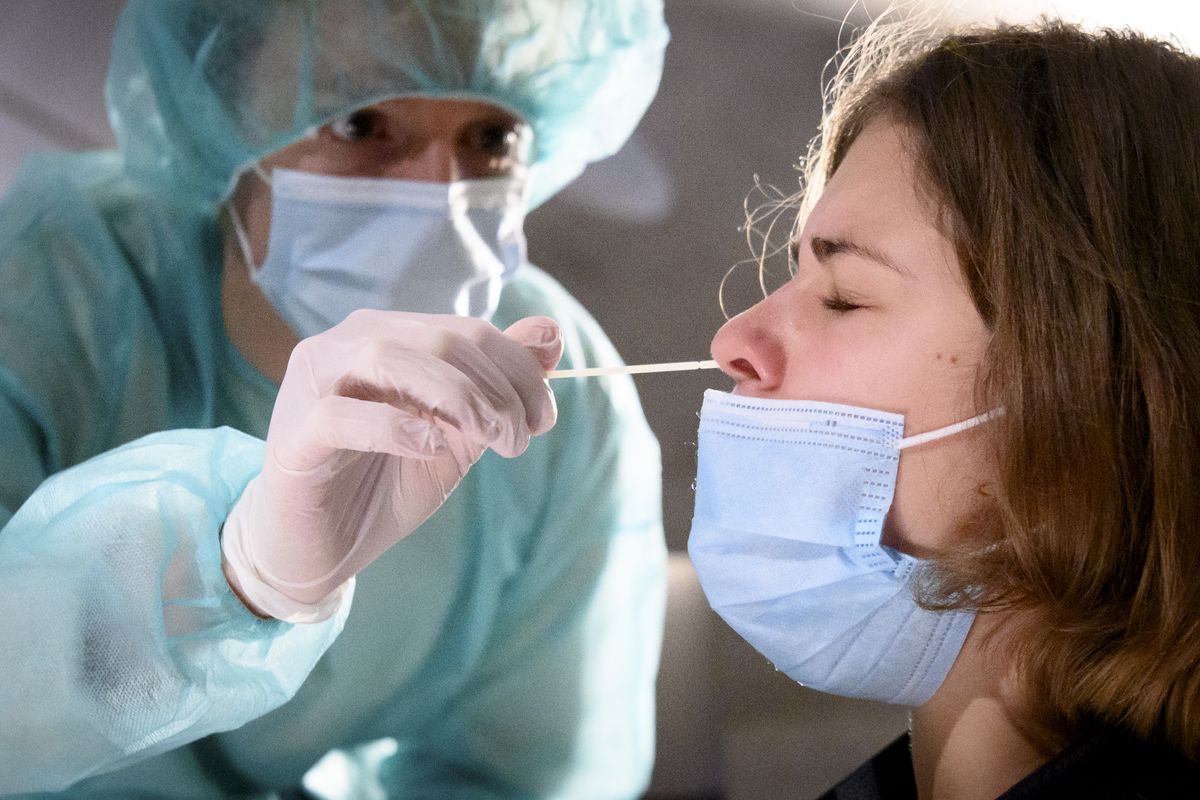 A health worker collects a nose swab sample for a polymerase chain reaction (PCR) test at the Mycorama coronavirus testing facility during the coronavirus disease (COVID-19) outbreak, in Cernier, Switzerland, Tuesday, Nov. 3, 2020.  (Laurent Gillieron)