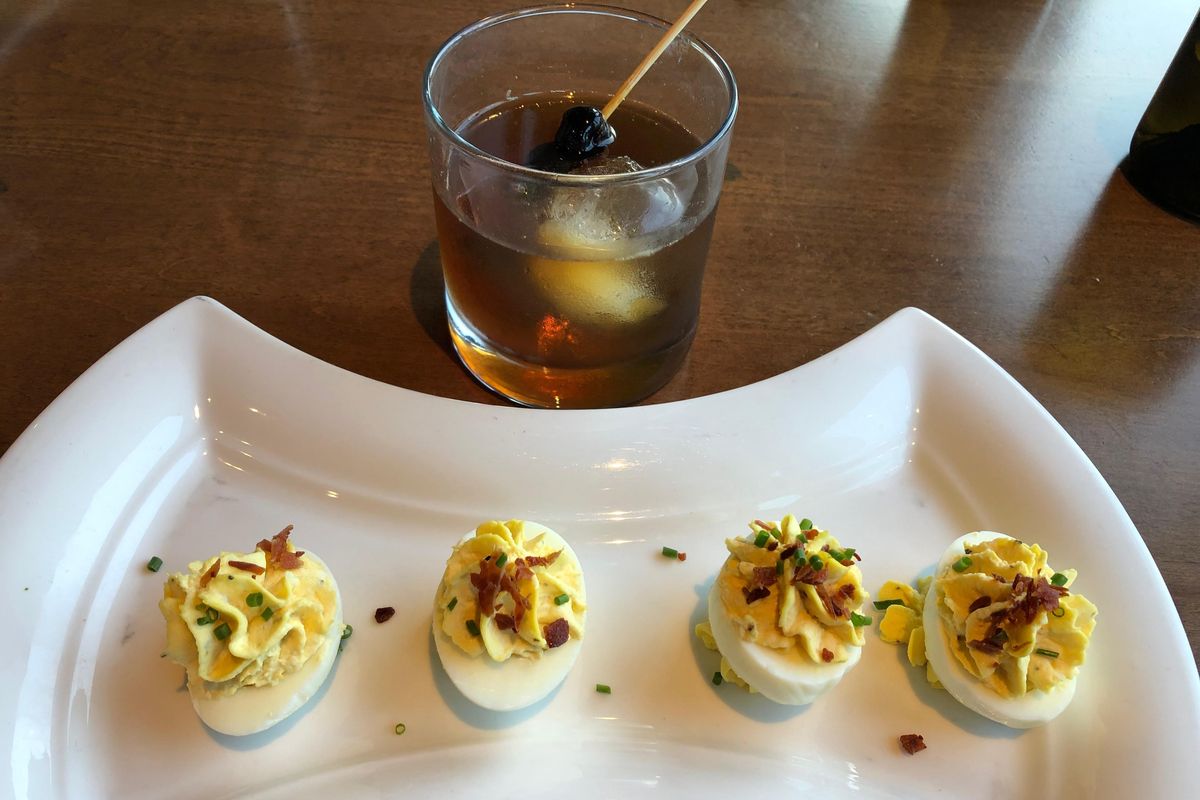 A Smoked Manhattan and Devilish Deviled Eggs at 1898 Public House at Kalispel Golf and Country Club. (Don  Chareunsy / The Spokesman-Review)