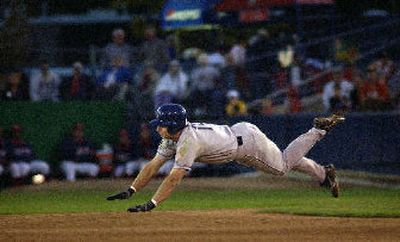 
The baseball beats Dust Devils' Daniel Carte to second base where he was tagged out by Indians second baseman Terry Blunt on Sunday.
 (Liz Kishimoto / The Spokesman-Review)