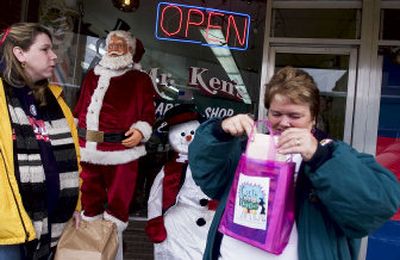 
Shelby Morgan, left, and her mother, Jane Bennett, shop for gifts in Spokane's Hillyard district Saturday during the 
