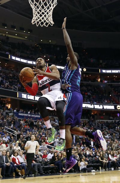 Wizards guard John Wall, left, scored 32 points in double-overtime win. (Associated Press)