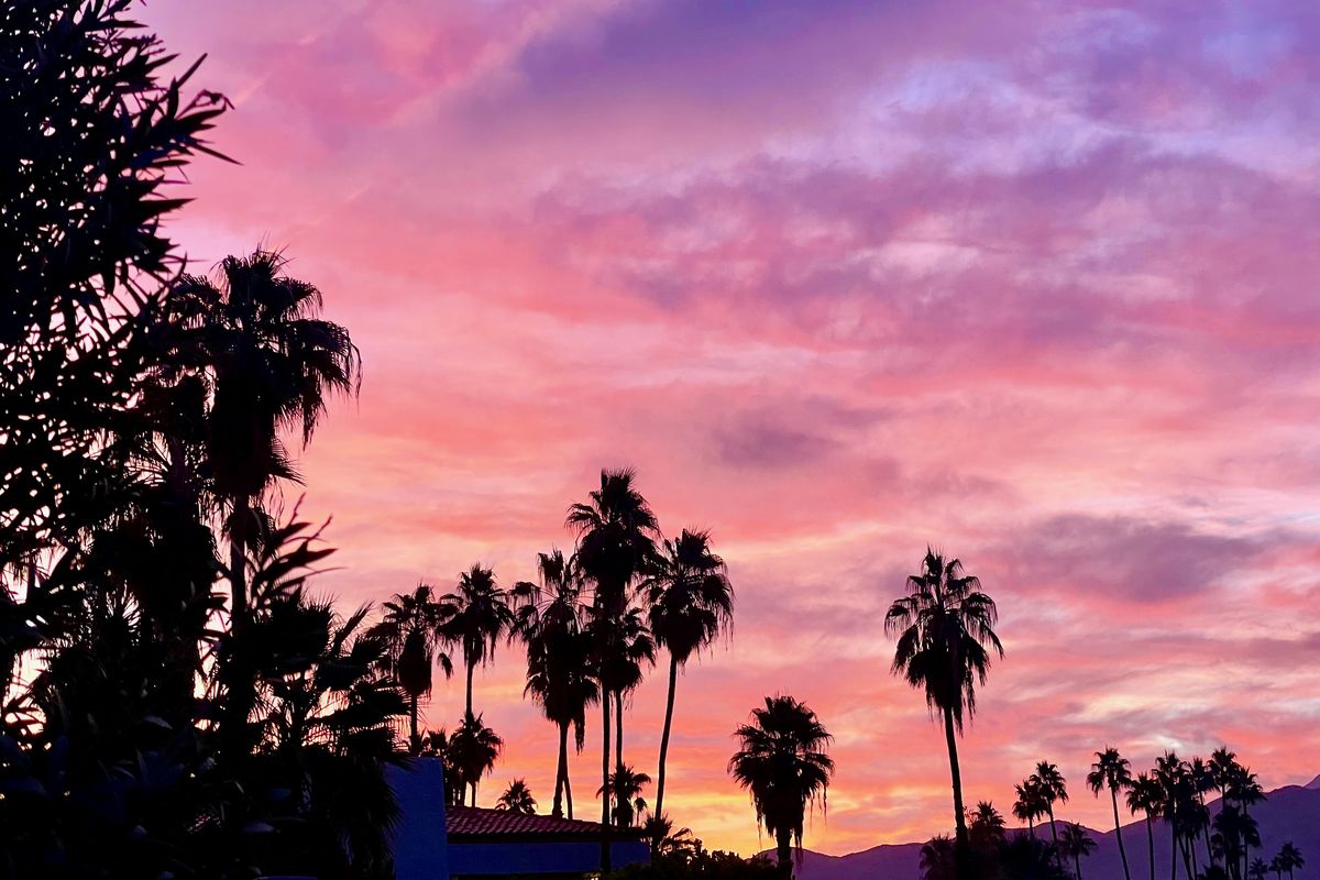 The sun rises over Palm Springs, turning the sky pink and orange. (Leslie Kelly)