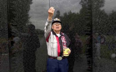 
Before performing a cleansing ceremony, Glen Douglas leaves tobacco as he asks for permission from the war dead to enter the sacred ground of the Vietnam War Memorial in Washington, D.C.
 (Colin Mulvany / The Spokesman-Review)