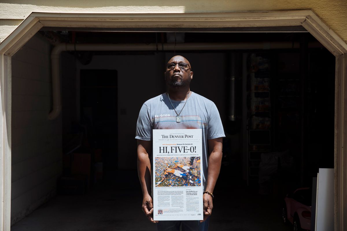 Bobby Thomas, father of Demaryius Thomas, with a Denver Post cover with a photo of his son, in Smyrna, Ga., on June 30, 2022. After Thomas died, his father fell into a depression that deepened as he learned more about the severity of chronic traumatic encephalopathy. (Kendrick Brinson/The New York Times)  (KENDRICK BRINSON)