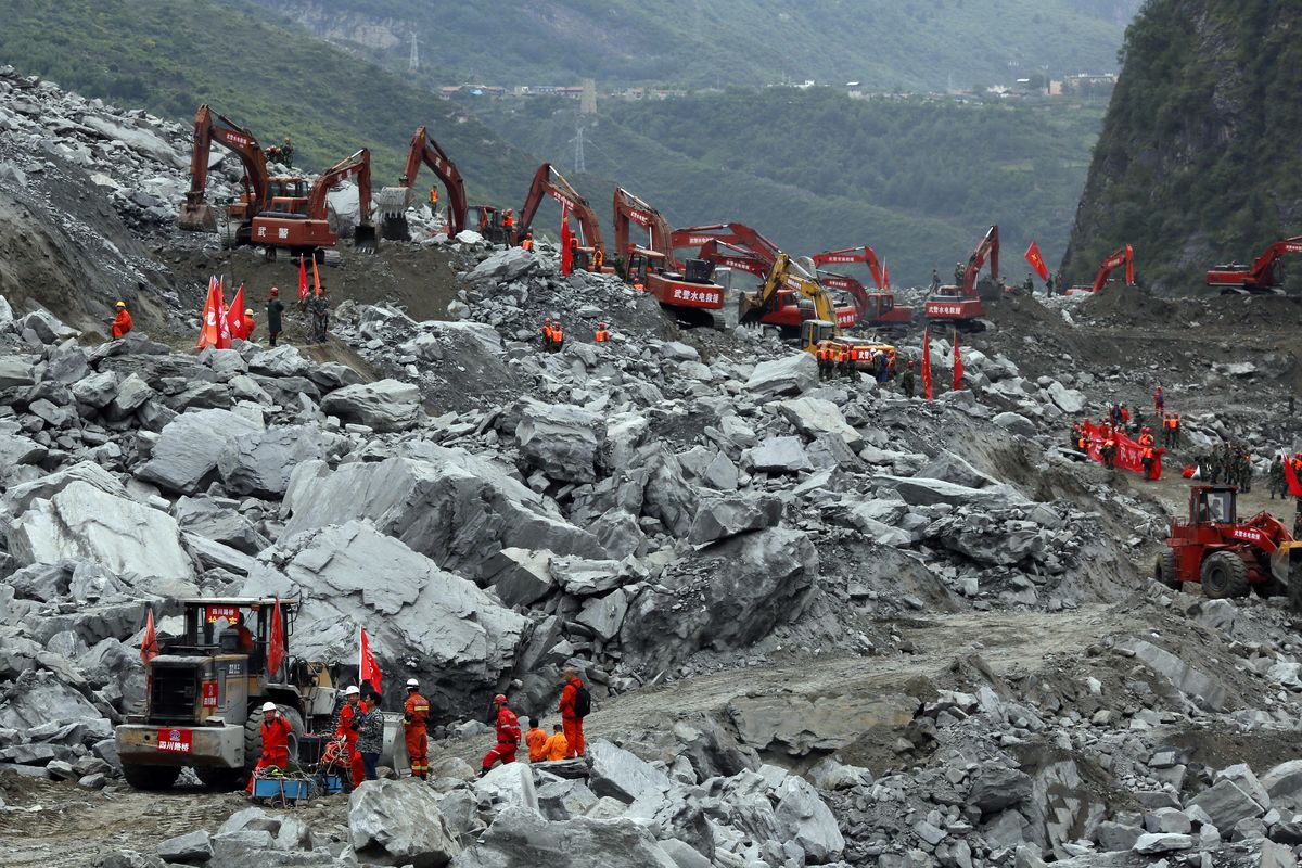 Heavy machinery is deployed to move debris during the search for victims at the site of a landslide in Maoxian County in southwestern China’s Sichuan Province, Sunday, June 25, 2017. Emergency crews are searching through the rubble for victims after a landslide Saturday buried a picturesque mountain village under tons of soil and rocks, with more than 100 people remained missing. (Ng Han Guan / Associated Press)