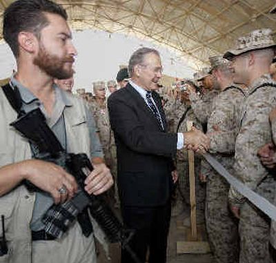 
Under tight security, Secretary of Defense Donald Rumsfeld greets the troops at the Al Asad Air Base in the Western Iraqi desert on Sunday. 
 (Associated Press / The Spokesman-Review)