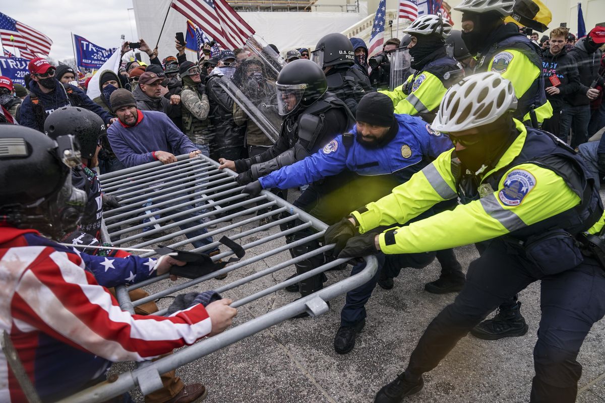 FILE - Rioters try to break through a police barrier at the Capitol in Washington, on Jan. 6, 2021. Egged on by soon-to-be former President Donald Trump, a crowd of demonstrators demanded that the electoral vote counting be stopped.  (John Minchillo)