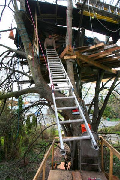 
David Csaky pulls up the ladder to his treehouse on Saturday. When the city told Csaky he had to leave his self-made home, citing health and safety concerns, friends bought an old RV for him to live in.
 (The Spokesman-Review)