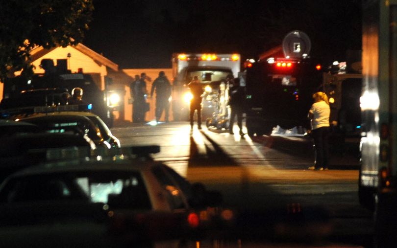 Spokane Police and members of the SWAT unit investigate after a stand-off with a man in a wrecked van ended with shots fired Monday, Sept. 26, 2011 near Seventh and Hatch in Spokane. Several shots were heard around 8:20.  (Jesse Tinsley)