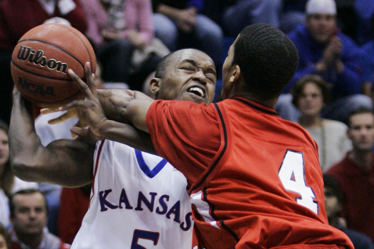 Kansas guard Rodrick Stewart (5) is fouled by Eastern Washington guard Gary Gibson (4) during the first half of a basketball game in Lawrence, Kan., Wednesday, Dec. 5, 2007.  (Orlin Wagner)