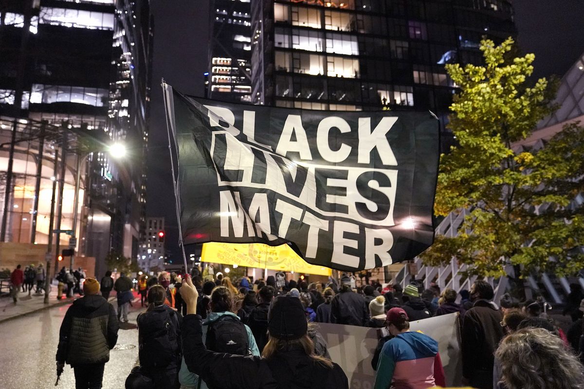 In this Nov. 4, 2020 photo, protesters representing Black Lives Matter and Protect the Results march in Seattle. A financial snapshot shared exclusively with The Associated Press shows the Black Lives Matter Global Network Foundation took in just over $90 million last year.  (Ted S. Warren)