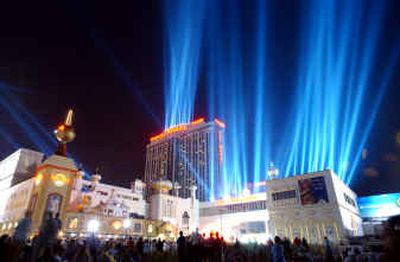 
Spectators watch Lights of Freedom at the Trump Taj Mahal in Atlantic City, N.J., last year. Donald Trump's casino businesses are being restructured under a bankruptcy protection plan that would strip The Donald of his majority stake. 
 (Associated Press / The Spokesman-Review)