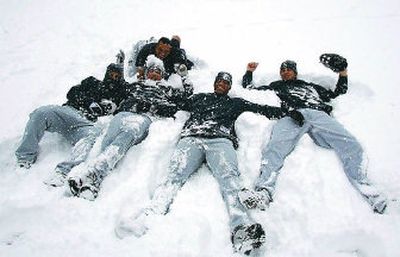 
 Sunday was another snow day for these Mariners players.
 (Associated Press / The Spokesman-Review)