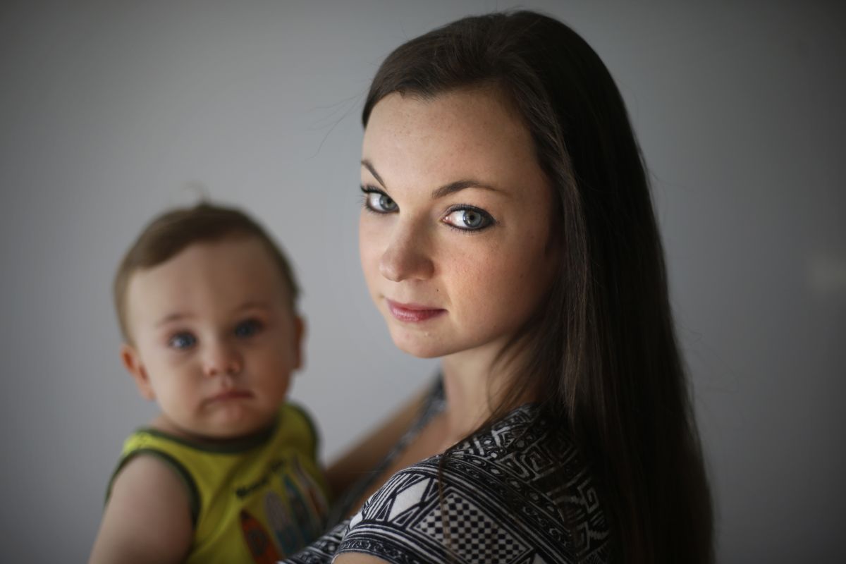 In this Aug. 23, 2012, photo, social worker Shannon Coyne poses for a portrait with her 11-month-old son in Philadelphia. Coyne and her husband decided against circumcision for their son.  The nation