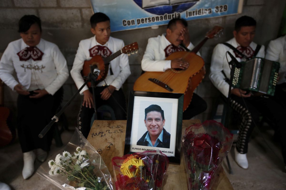 A framed portrait of Elfego Miranda Diaz, a Guatemalan migrant who was killed near the U.S.-Mexico border in January, sits on top of the coffin that contains his remains in Comitancillo, Guatemala, Saturday.  (Moises Castillo)