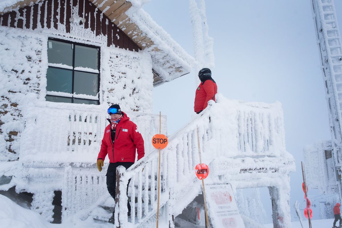 Daniel Voltz, left, walks out of 49 Degrees North’s ski patrol hut on Dec. 27.  (Eli Francovich/The Spokesman-Review)
