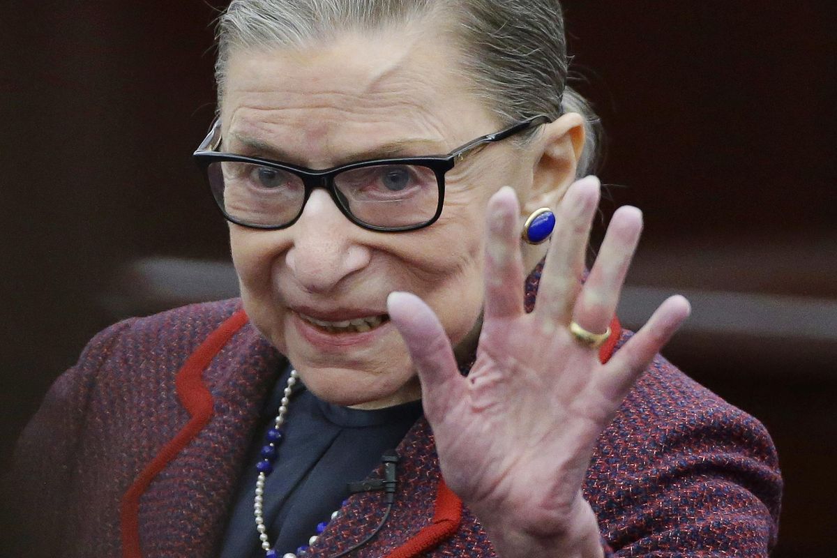 Supreme Court Justice Ruth Bader Ginsburg waves Jan. 30, 2018, in acknowledgement of the applause she receives as she arrives for a “fireside chat” in the Bruce M. Selya Appellate Courtroom at the Roger William University Law School in Bristol, R.I. Ginsburg said she likes actress-comedian Kate McKinnon’s imitation of her in NBC’s “Saturday Night Live.” (Stephan Savoia / Associated Press)