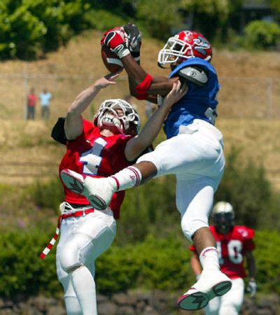 
North Central's Shane Thomas, left, of the East team knocks the ball loose from West receiver Dante Calcotte of Renton. 
 (Jennifer Buchanan Everett Herald / The Spokesman-Review)