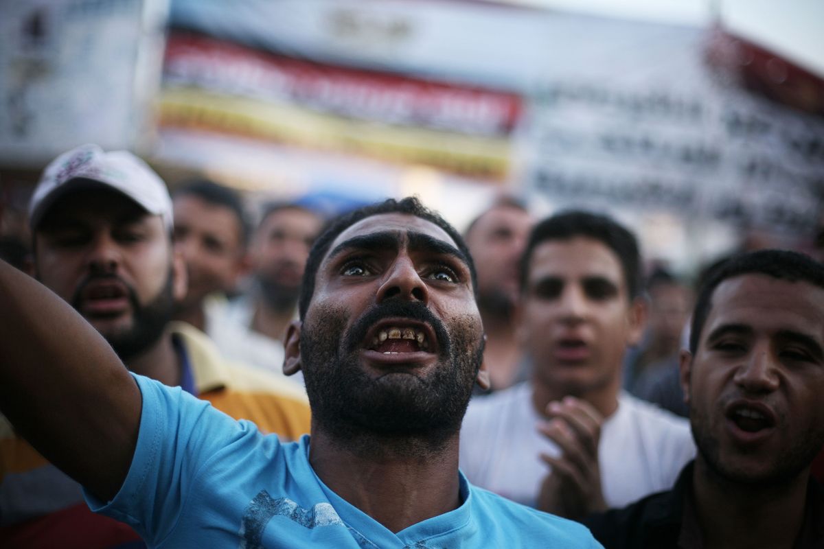 Egyptian protesters shout slogans in Tahrir Square as the country awaits the outcome of a presidential runoff vote in Cairo on Saturday. (Associated Press)