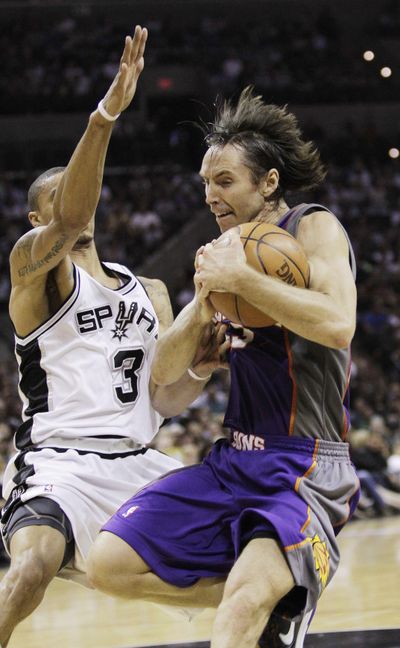 Suns guard Steve Nash is defended by the Spurs’ George Hill. Nash finished with 20 points and nine assists in 107-101 win. (Associated Press)